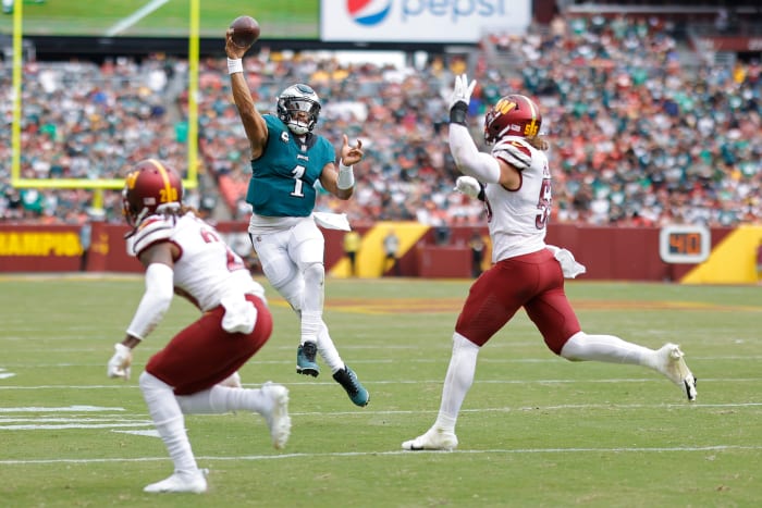 Washington Commanders defend a pass from Philadelphia Eagles quarterback, Jalen Hurts (1).